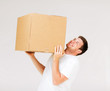 © Syda Productions - man carrying carton heavy box