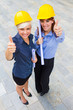 © Francesco83 - Female constructors making positive thumb gesture while smiling