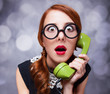 Redhead women with green telephone.