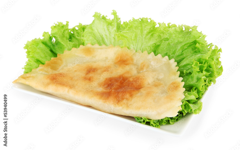 Tasty cheburek with fresh herbs on plate,isolated on white