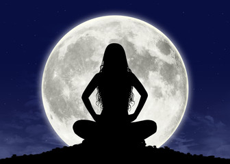 young woman in meditation at the full moon