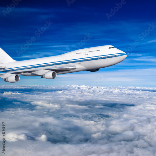 Plakat na zamówienie passenger airplane in the clouds.