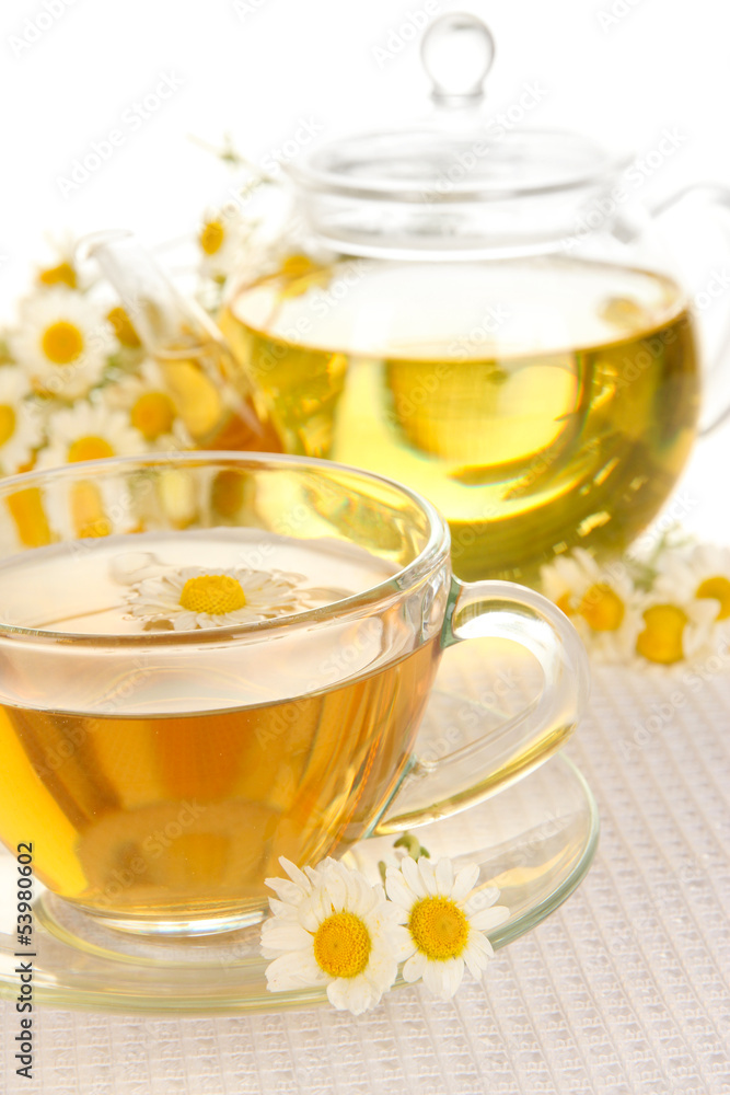 Cup of herbal tea with camomiles close up