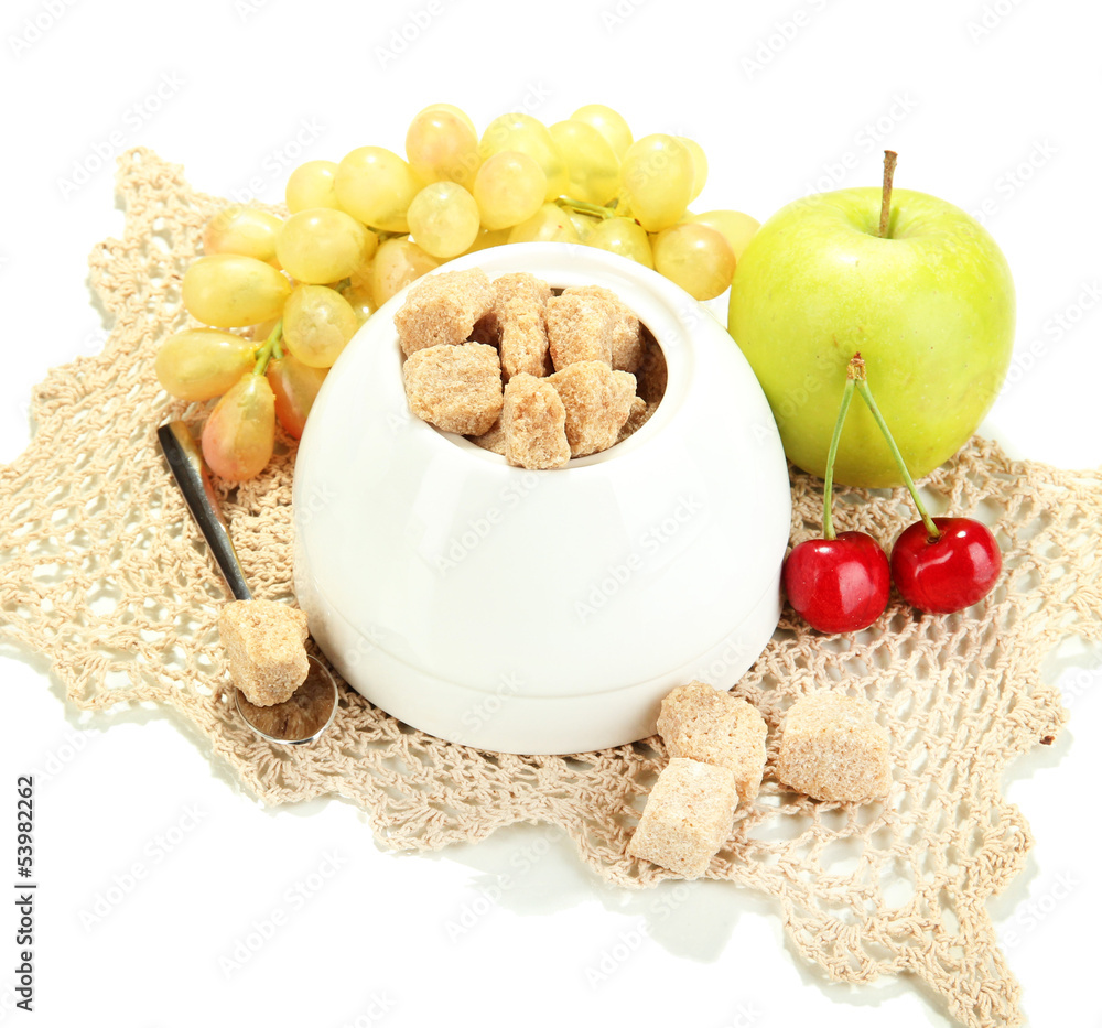 Unrefined sugar in white sugar bowl on grey background