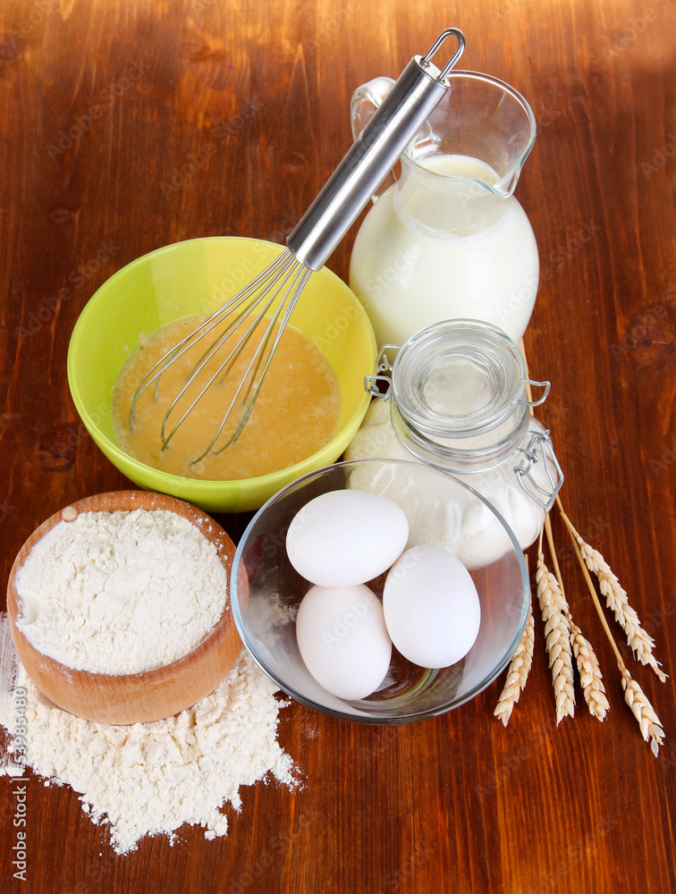 Ingredients for dough on wooden table close-up