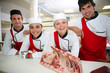 © goodluz - Happy team of young butchers in school kitchen
