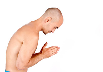 Spiritual topless man praying, meditating and doing yoga.