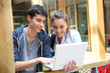 © goodluz - Teenagers working on laptop in school campus