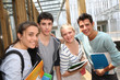 © goodluz - Cheerful students standing outside school building