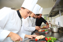 Team Of Young Chefs Preparing Delicatessen Dishes
