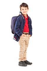 Full length portrait of a school boy with backpack standing