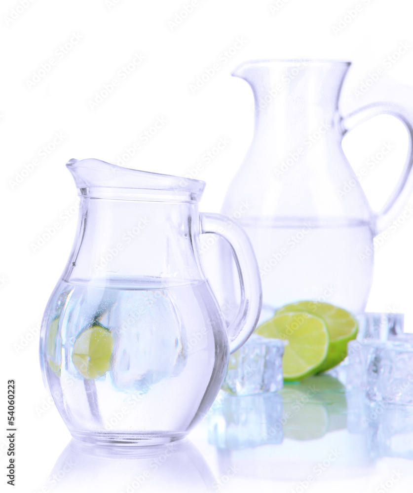 Glass pitchers of water with ice and lime isolated on white