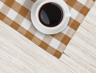 Wall Mural - coffee cup top view on tablecloth over wooden table