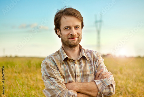 Fotografía Happy farmer standing in front of his fields