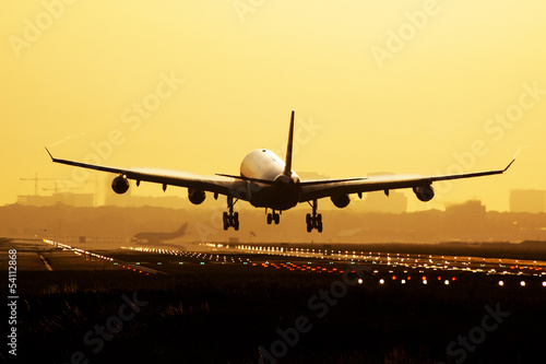 Fototapeta dla dzieci Airplane sunrise landing