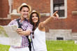 © gpointstudio - Woman pointing at something to her boyfriend during sightseeing