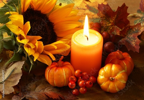 Arrangement of sunflower, candle and autumn decorations Plakat