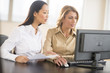 © tmc_photos - Businesswomen Using Desktop PC