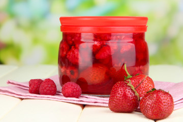 Poster - Home made berry jam on wooden table on bright background