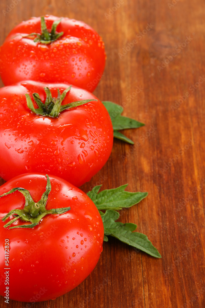 Fresh tomatoes on wooden background