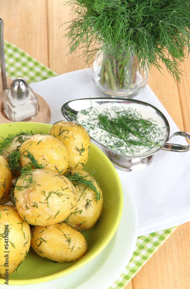 Boiled potatoes on platens on on napkins on wooden table