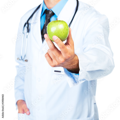Nowoczesny obraz na płótnie Doctor's hand holding a fresh green apple close-up on white