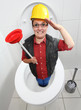 Funny repairman with toilet plunger cleaning the toilet bowl.
