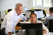 © goodluz - Teacher with student working on desktop computer