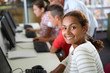 Smiling student girl sitting in computing class