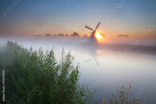 Fototapeta na wymiar summer sunrise over river and windmill