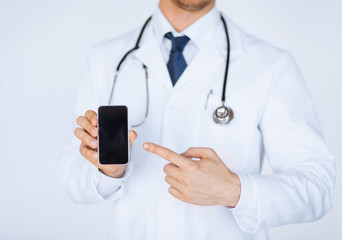 Wall Mural - doctor pointing at smartphone