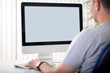 © luckybusiness - Man looks at the screen.