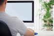 © luckybusiness - Man in front of computer, back view