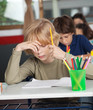 © Tyler Olson - Bored Schoolboy Sitting At Desk In Classroom