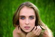 © Nick Starichenko - Beautiful face of the woman against greenn grass background