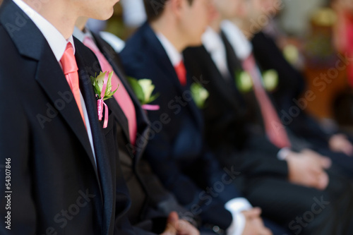 Leinwand Poster  Wedding boutonniere on jacket of groom's man
