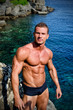 © theartofphoto - Handsome young bodybuilder shirtless by the sea or ocean