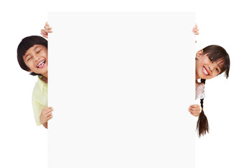 Children posing with a white board