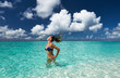 © haveseen - Woman splashing water with hair in the ocean