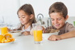 © WavebreakmediaMicro - Cheerful siblings eating cereal together