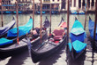 Venice seafront with gondolas on the waves