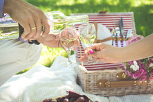 Two Glasses Of White Wine With Picnic Basket. 