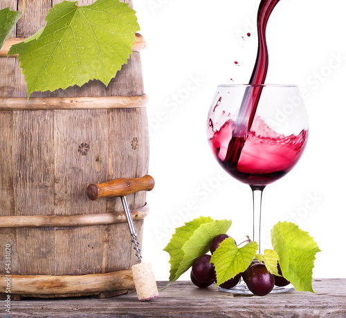 Fototapeta na wymiar Red wine, glass and barrel with grapes