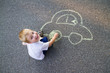 © laniko - Boy drawing car with chalk