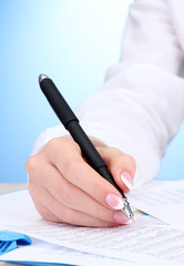 Wall Mural - Closeup of businesswoman hands, writing on paper