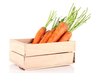 Wall Mural - Carrots in wooden crate, isolated on white