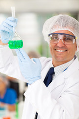 Wall Mural - senior medical researcher holding a flask