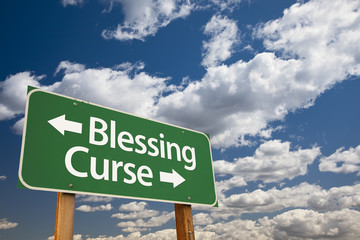 Wall Mural - Blessing, Curse Green Road Sign and Clouds