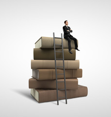 Sticker - businessman sitting on books