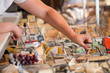 © Milles Studio - Unrecognizable male supermarket worker with cheese closeup